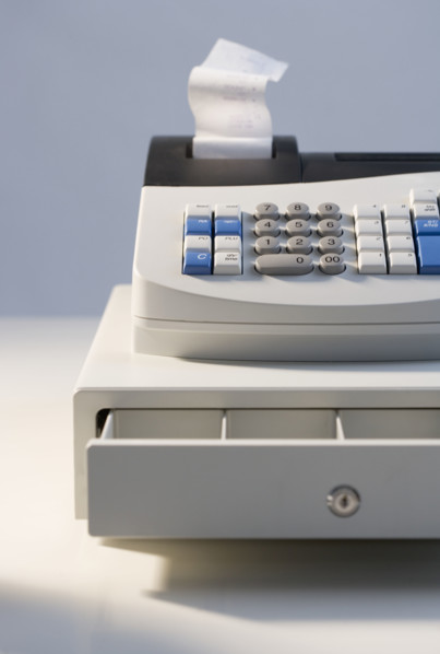 Cash register with open drawer.