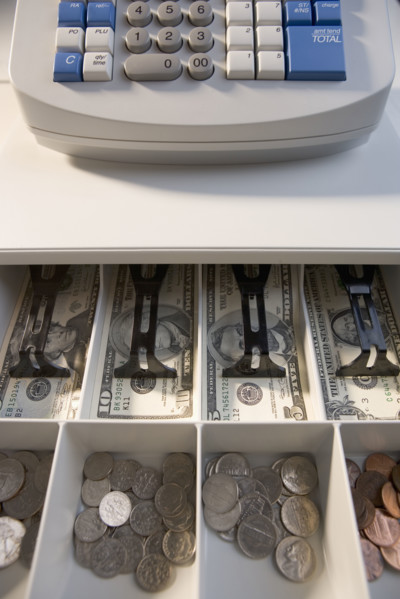Register with open drawer of money.