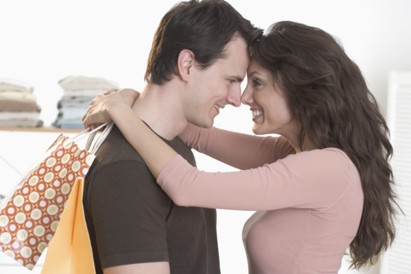 Couple embracing with foreheads touching.