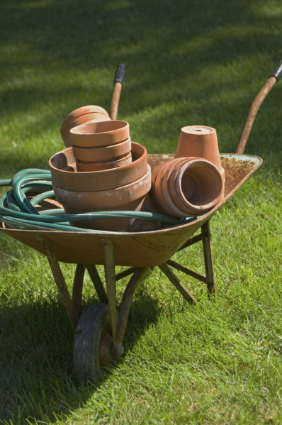 Wheelbarrow and gardening tools.