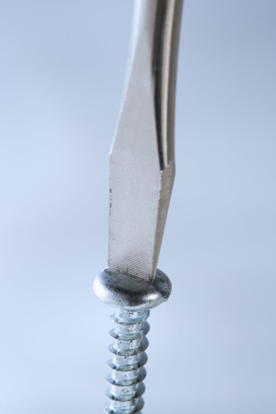Closeup of screwdriver and screw.