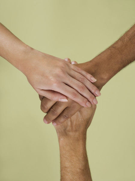 Holding hands in multiracial group.