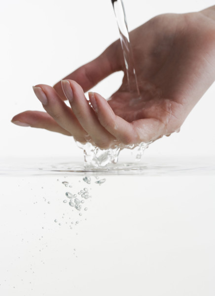 Hand touching water.