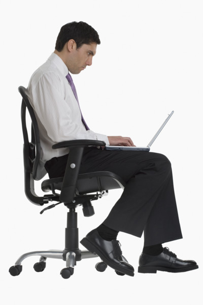 Businessman typing on laptop.