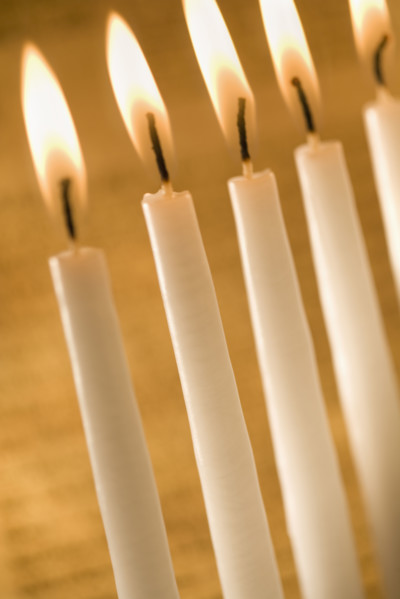Candles burning in a menorah.