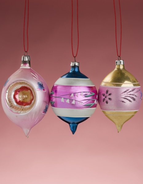 Three hanging Christmas ornanaments.