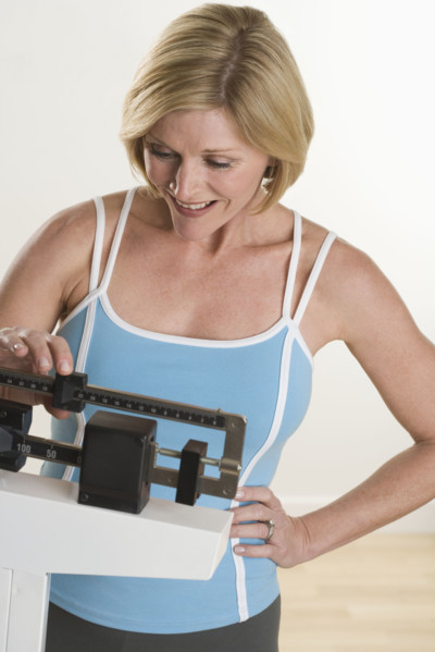 Woman weighing herself.
