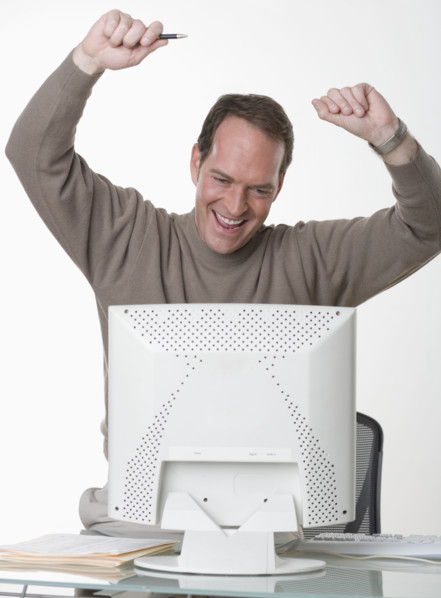 Exuberant man at his computer.