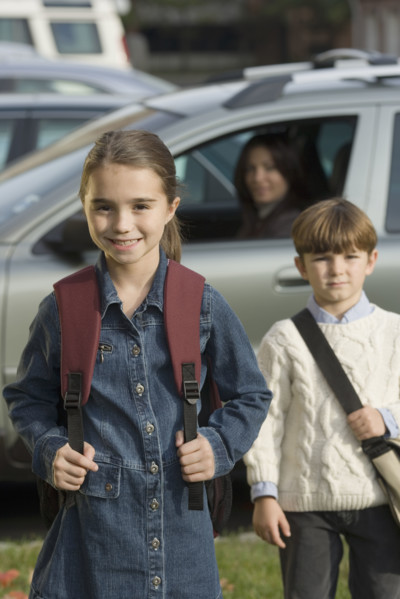 Mother dropping children off at school.