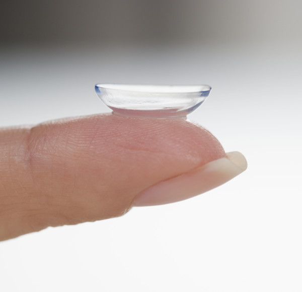 Closeup of finger with contact lens.