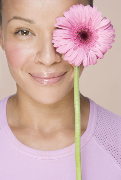 Woman with flower over one eye.