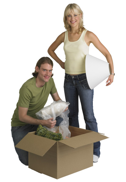 Couple unpacking box on moving day.