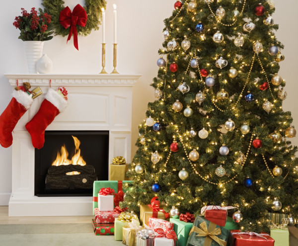 Christmas tree with presents and fireplace with stockings.