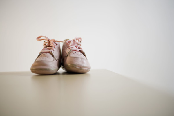 Pair of baby shoes on table.