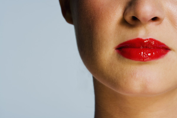 Closeup of female face with red lips.