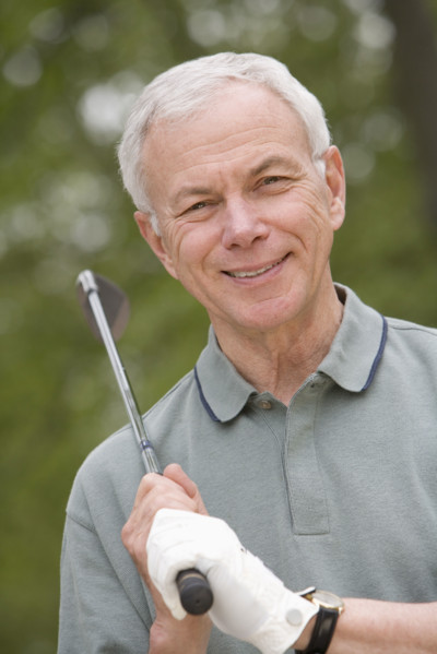 Portrait of senior man with golf club.
