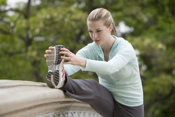 Woman stretching in park.