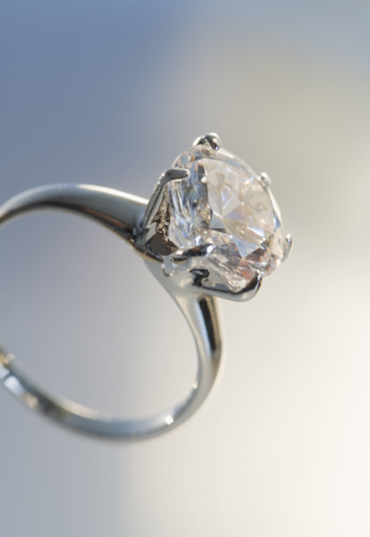 Diamond like ring in six pronged silver setting.
