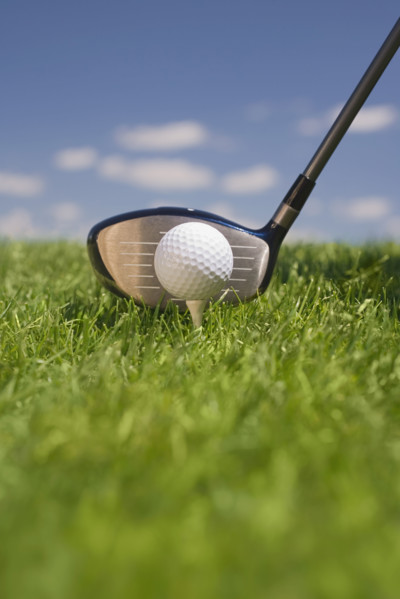 Closeup of golf ball teed up for play.