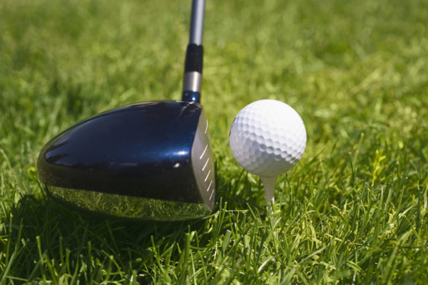 Closeup of golf ball teed up for play.