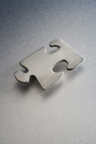 Metallic jigsaw puzzle piece.