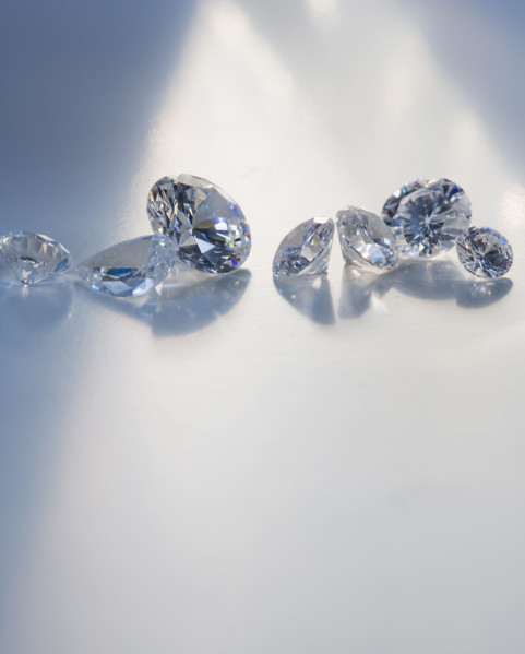 Seven diamond like gems on table.