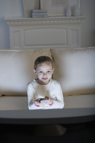 Young girl watching television .