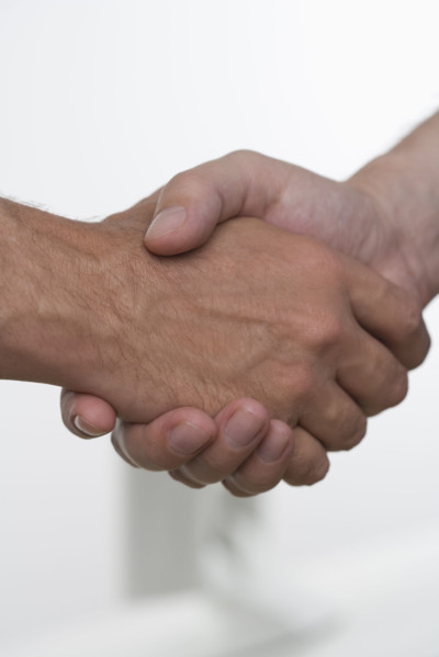 Closeup of men shaking hands.