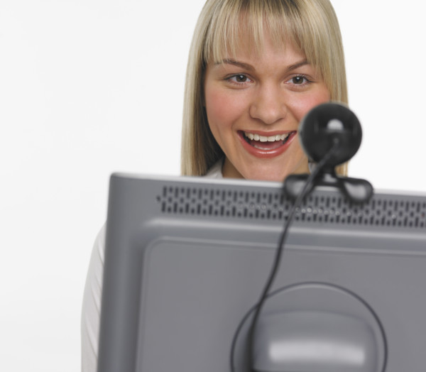 Studio shot of woman using webcam.