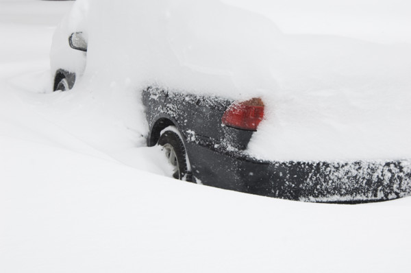 Car buried in snow in winter.