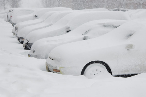Cars buried in snow.