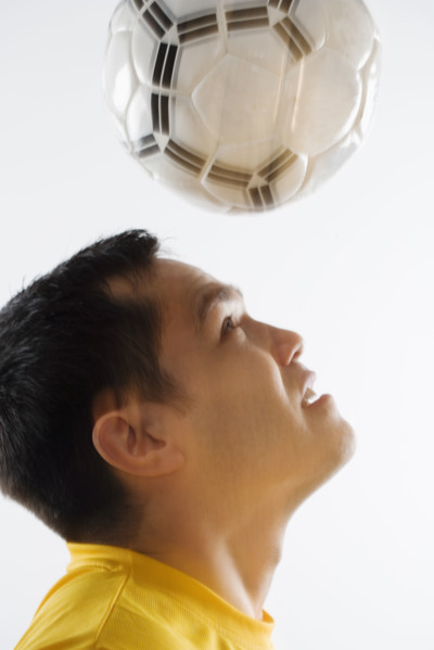 Man playing with soccer ball.