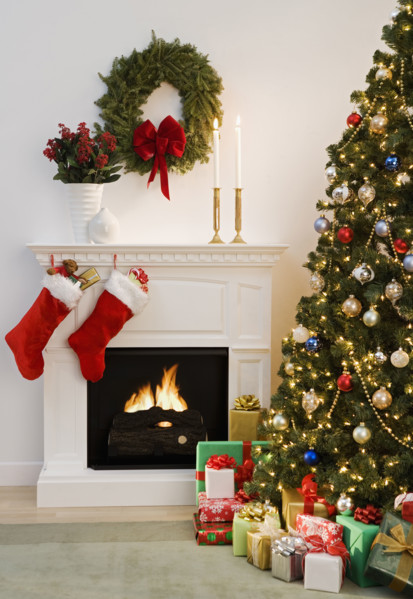 Christmas tree with presents and fireplace with stockings.