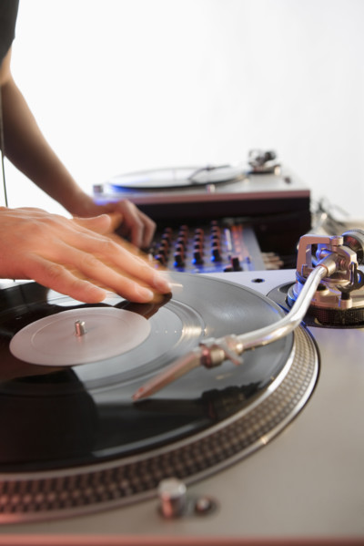 Person mixing sound from records.