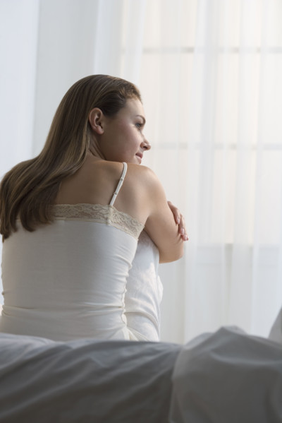 Woman relaxing on her bed.