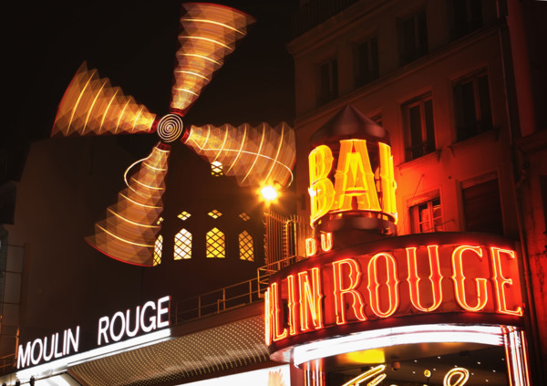 Neon signs in urban scene, Moulin Rouge, Paris, France.