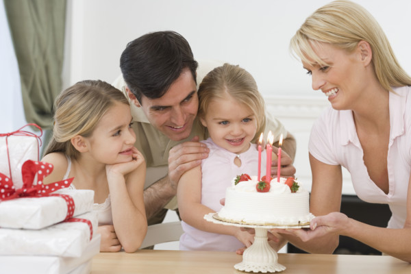 Girl celebrating birthday with family.