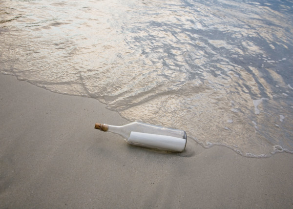 Message in bottle on beach.