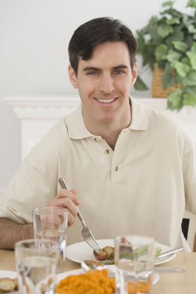 Portrait of man at dinner table.