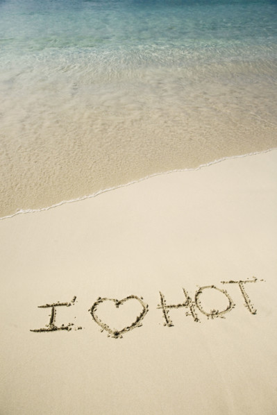 I Love Hot written in sand.