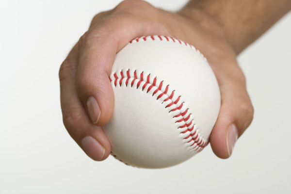 Close up of pitcher holding baseball.