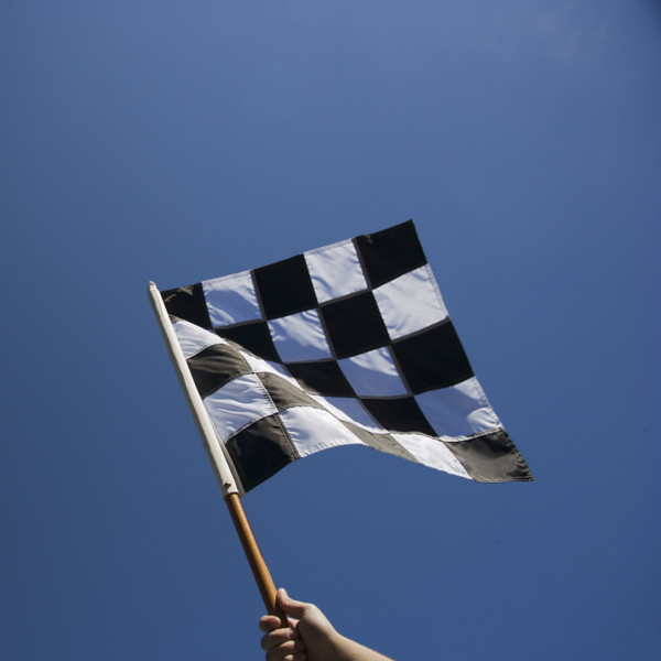Checkered flag with blue sky.