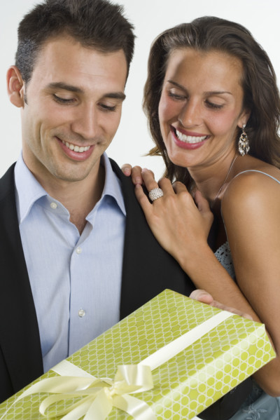 Woman giving man gift.