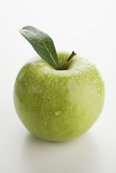 Close up of apple with water droplets.