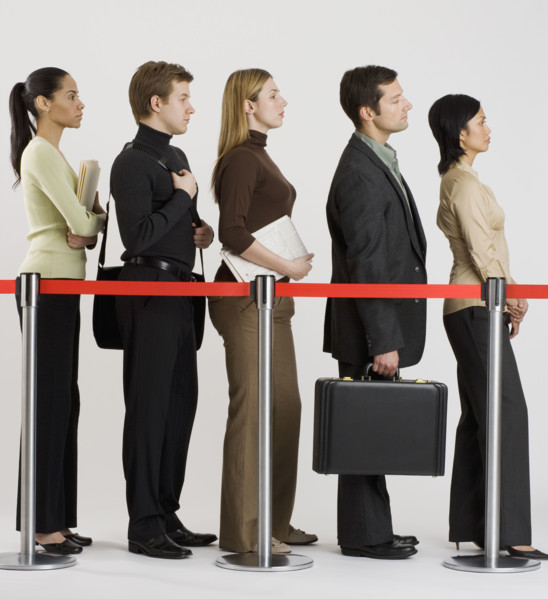 Group of people standing in line.