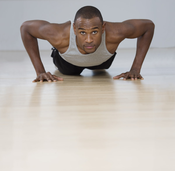 Man doing pushups indoors.