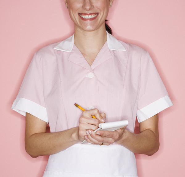 Waitress writing order on pad.