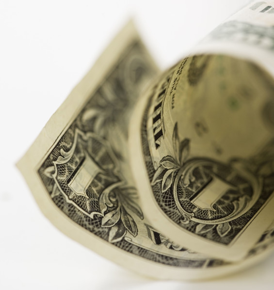 Close up of curled dollar bill.