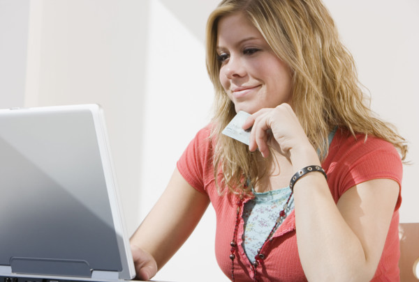 Woman shopping online with laptop.