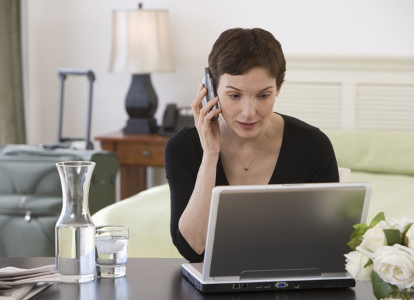 Businesswoman working in hotel room.